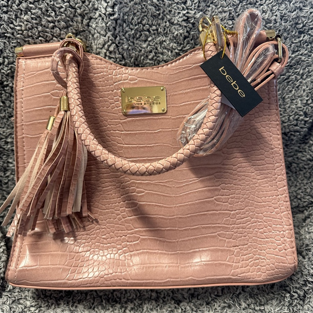 bebe purse. Color is dusty pink. Brand new with tags. Never been used.